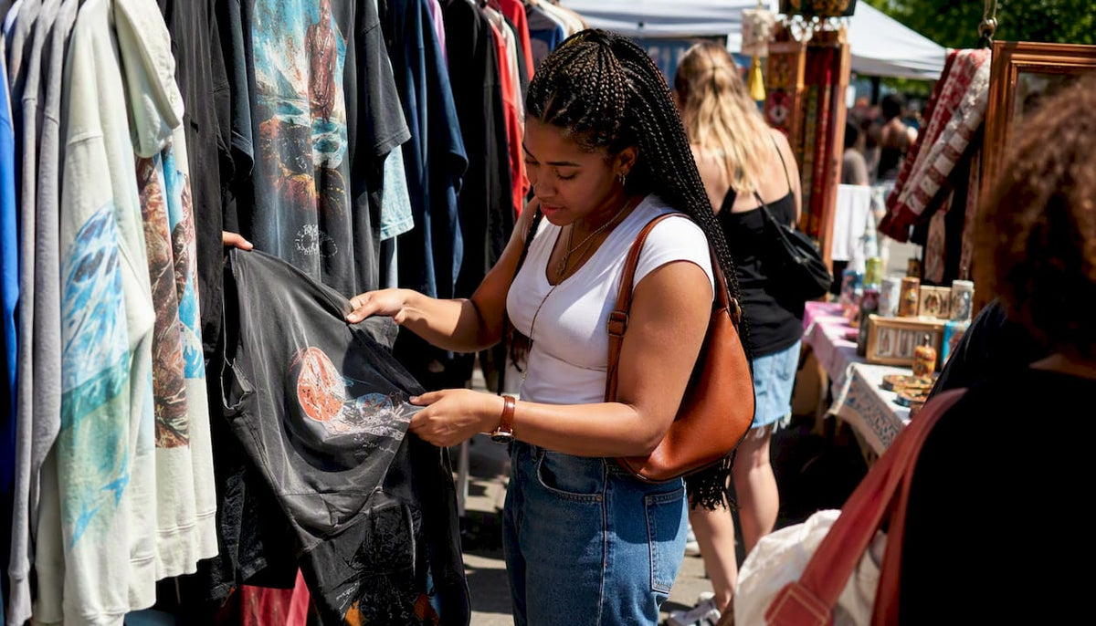 Woman browsing streetwear clothing in boutique