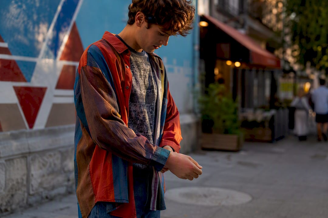 Layered denim jacket and striped sweatshirt on youth