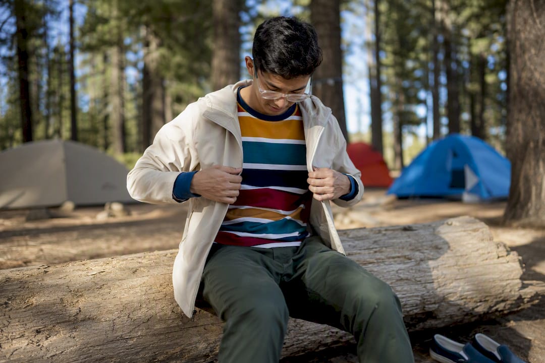Young adult adjusting layered casual camp outfit