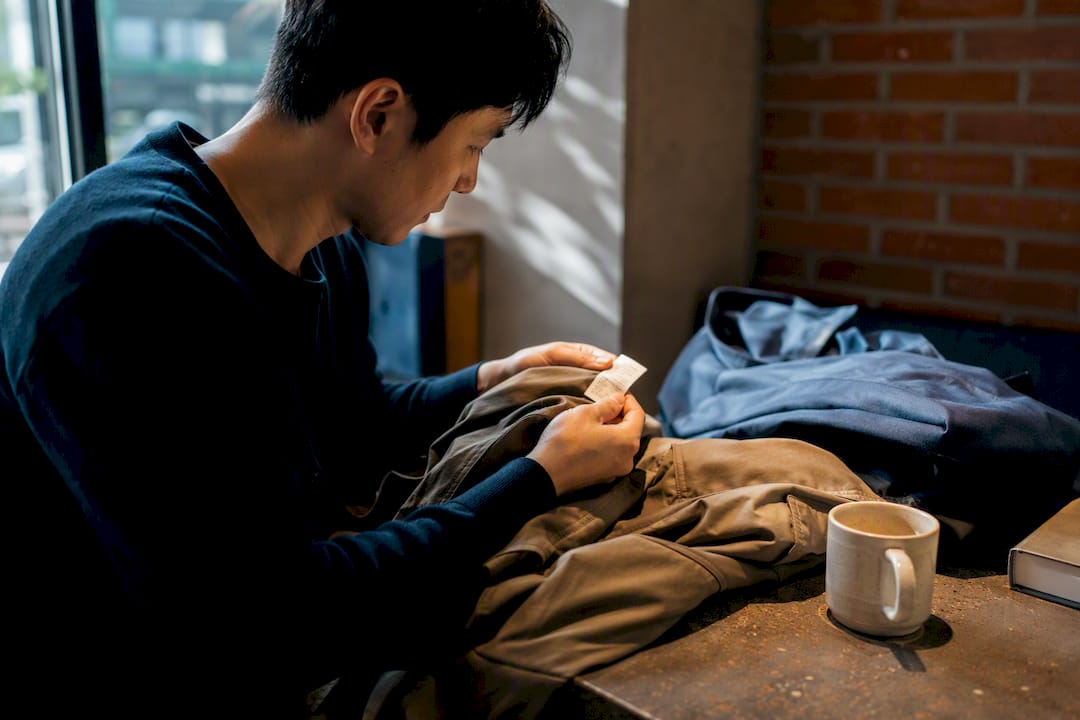 Hands examining ethical clothing tag closely