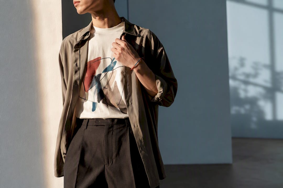Cropped graphic tee outfit with layered neutrals