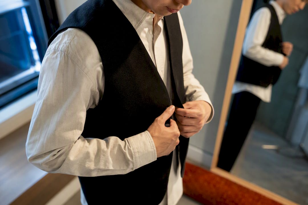 Layered vest being adjusted for fit