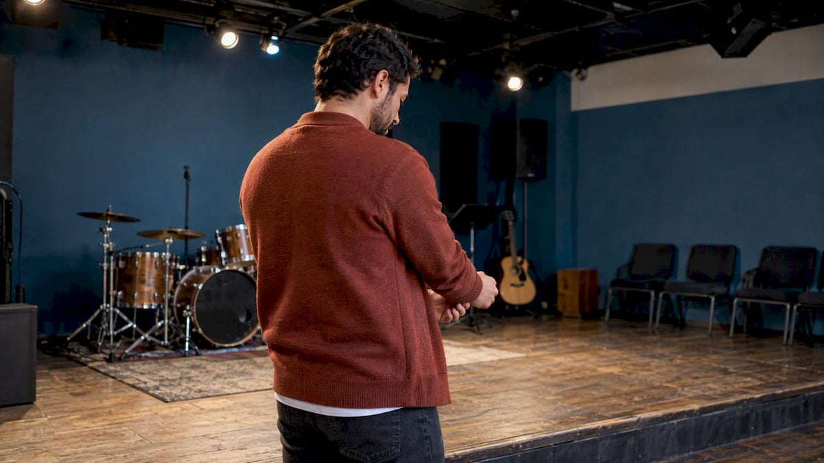 Youth pastor checking outfit under stage lights